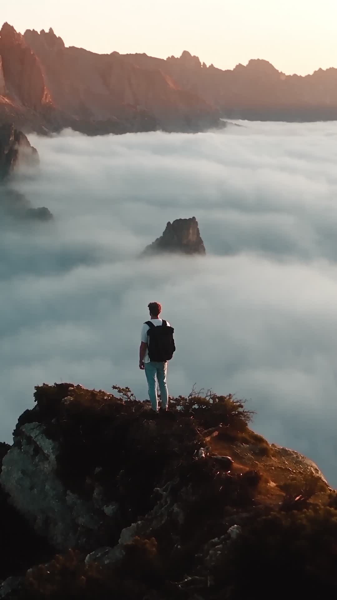 Hiker on Rock Spur Above Sea of Clouds at Sunrise