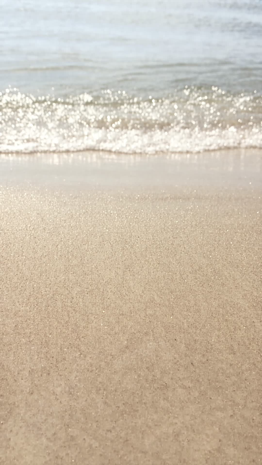 Waves Washing Over Golden Sand