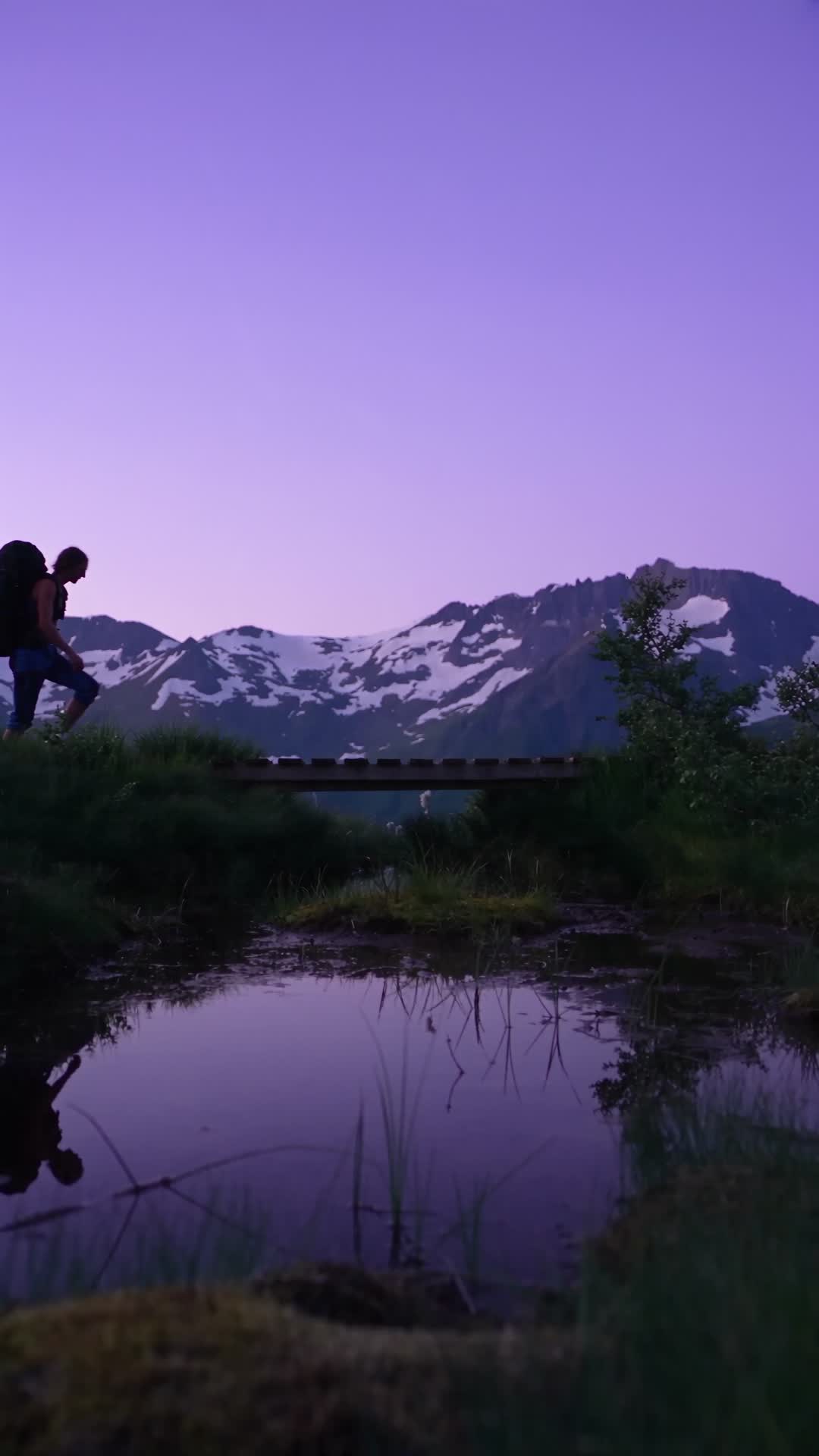 Hiker Crossing Footbridge at Dusk